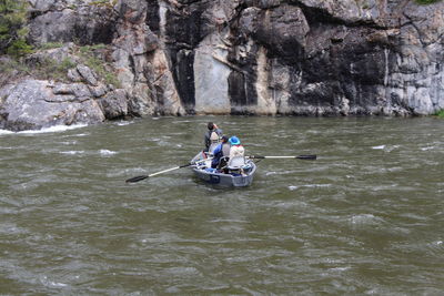 Man sitting on rock in river