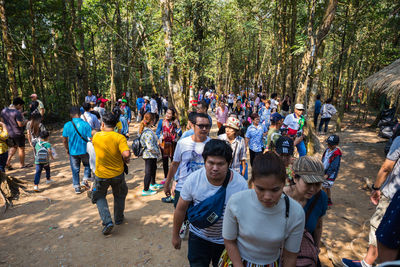 Group of people walking in forest