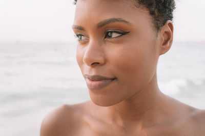 Close-up of woman looking away at beach