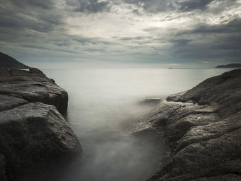 Scenic view of sea against cloudy sky