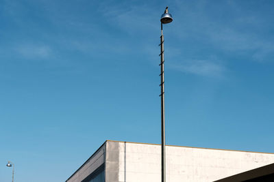 Low angle view of street light against building