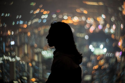 Woman standing at night