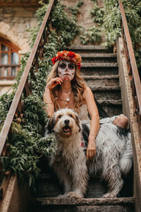 Portrait of young woman with dog