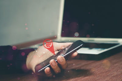 Midsection of woman using mobile phone