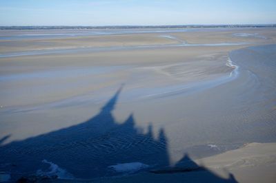 Scenic view of beach against sky during winter