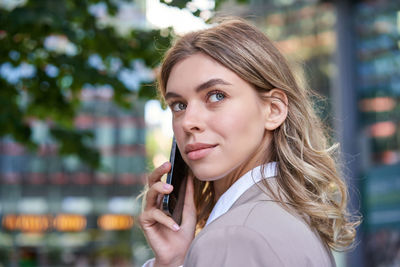 Portrait of young businesswoman using mobile phone