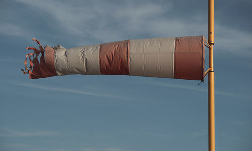 A torn windsock during a strong wind. device for controlling the strength and direction of the wind