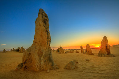 Panoramic view of rock formations against sky during sunset