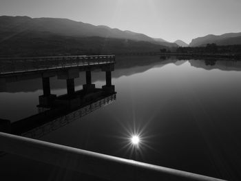 Bridge over river against sky during sunset