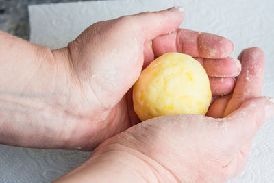 Close-up of dough in cupped hands