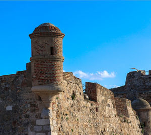 Low angle view of old ruins against clear blue sky