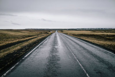 Empty road on landscape against sky