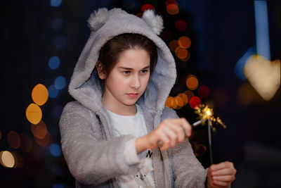 Portrait of woman holding christmas tree