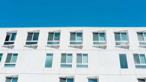 Low angle view of building against clear blue sky