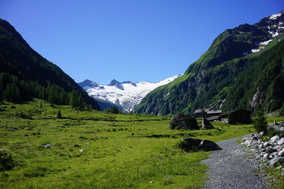 Scenic view of mountains against blue sky