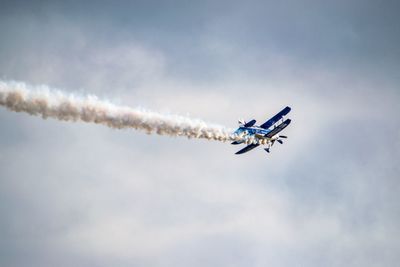 Low angle view of airplane flying in sky