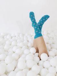 Woman amidst balls against white background