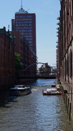 View of boats in river against buildings