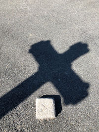 Shadow of man on road