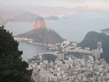 Aerial view of cityscape by sugarloaf mountain in foggy weather