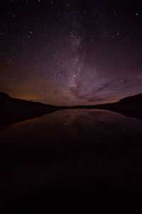 Scenic view of lake against star field at night