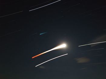 Low angle view of illuminated lights at night