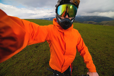 Young man takes a selfie while training in the mountains on a bike. a man in a helmet and sportswear