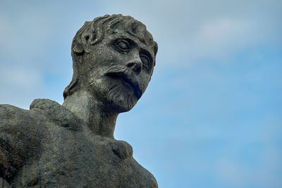 Low angle view of statue against blue sky