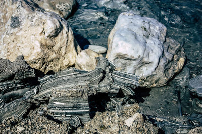 Rock formation on beach against sky