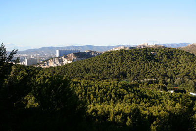 View of cityscape against clear blue sky