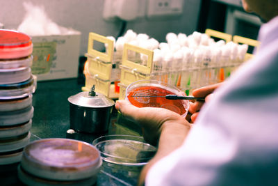 Close-up of person hands experimenting in laboratory