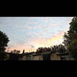 Low angle view of built structure against sky at sunset