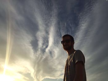 Low angle view of man standing against sky