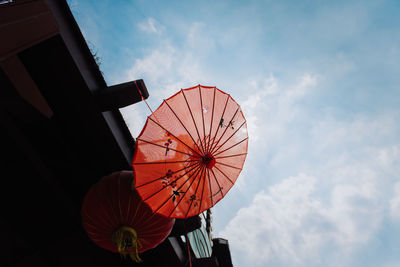 Low angle view of ferris wheel against sky