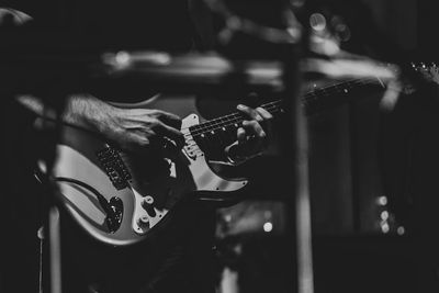 Cropped hand of man playing guitar