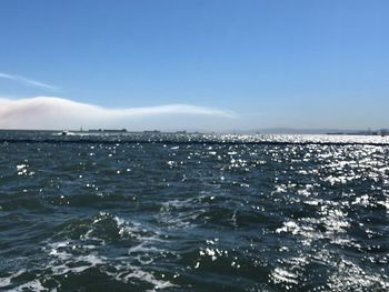 Scenic view of sea against blue sky