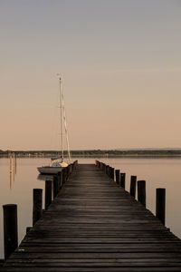 Pier over sea against clear sky