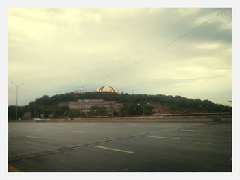 Road against cloudy sky