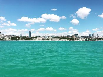 Scenic view of sea and buildings against sky