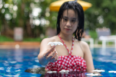 Portrait of woman holding swimming pool