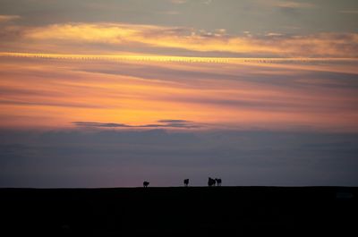 Scenic view of silhouette land against sky during sunset