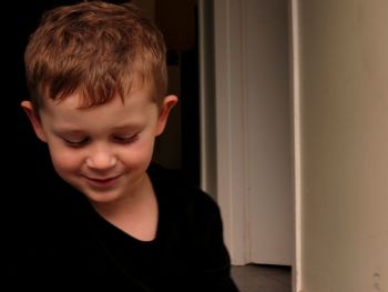 Close-up of smiling boy at home