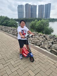 Full length portrait of boy in city