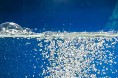 Close-up of bubbles in blue water