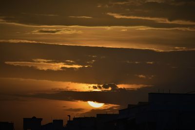 Low angle view of silhouette buildings against sky during sunset