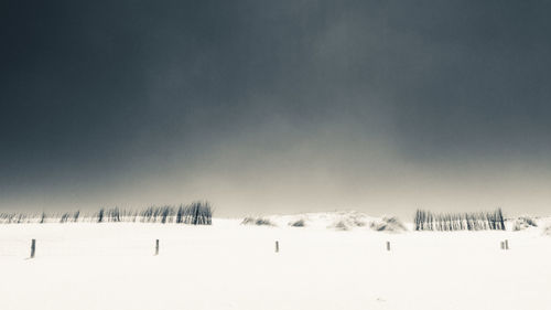 Panoramic view of snow on field against sky