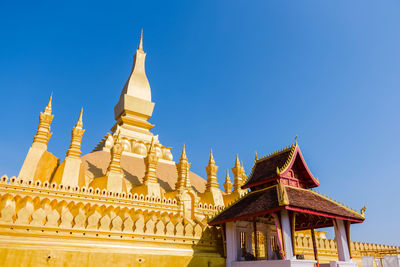 Low angle view of temple building against clear blue sky