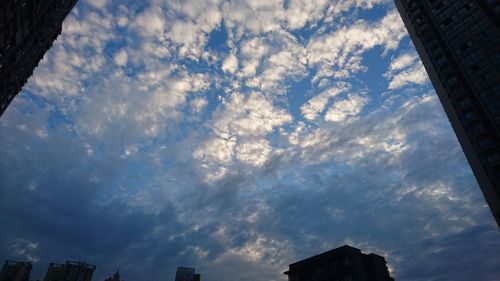 Low angle view of building against cloudy sky