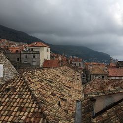 High angle shot of townscape against cloudy sky