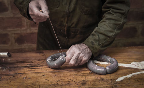 Midsection of man working at workshop